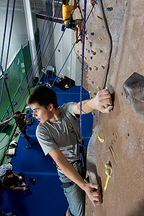 college student climbing wall