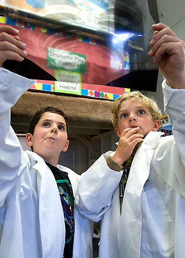 Boys dressed as doctors look at xray